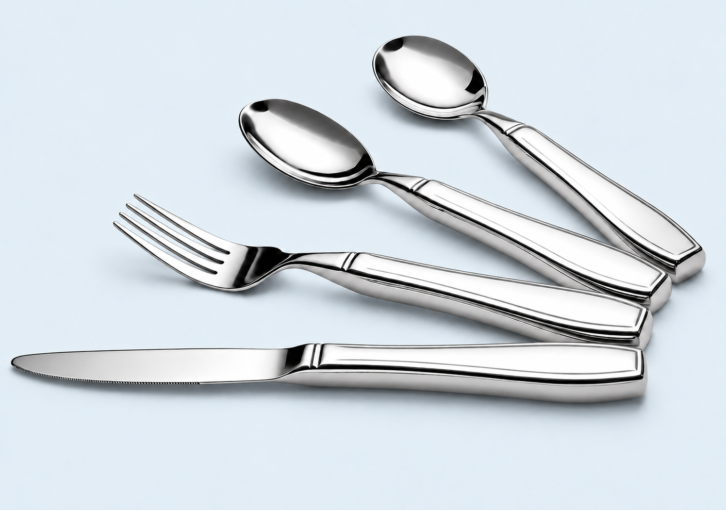 Presteem weighted utensils for hand tremors: polished stainless-steel dinner knife, dinner fork, oval dinner spoon and round soup spoon, on a pale-blue background.